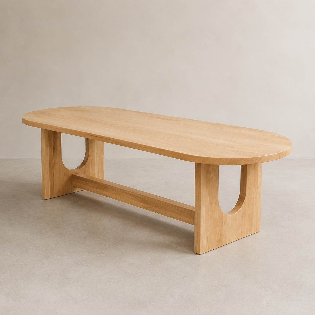 A minimalist oval wooden dining table with a light natural elm finish, featuring a lower support rail and U-shaped cutouts in the legs, set against a neutral concrete-textured background.