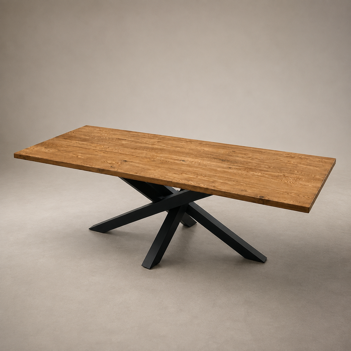 A rectangular wooden dining table with a warm medium-brown wood grain top and a black metal X-shaped pedestal base, photographed in a studio setting against a neutral beige backdrop.