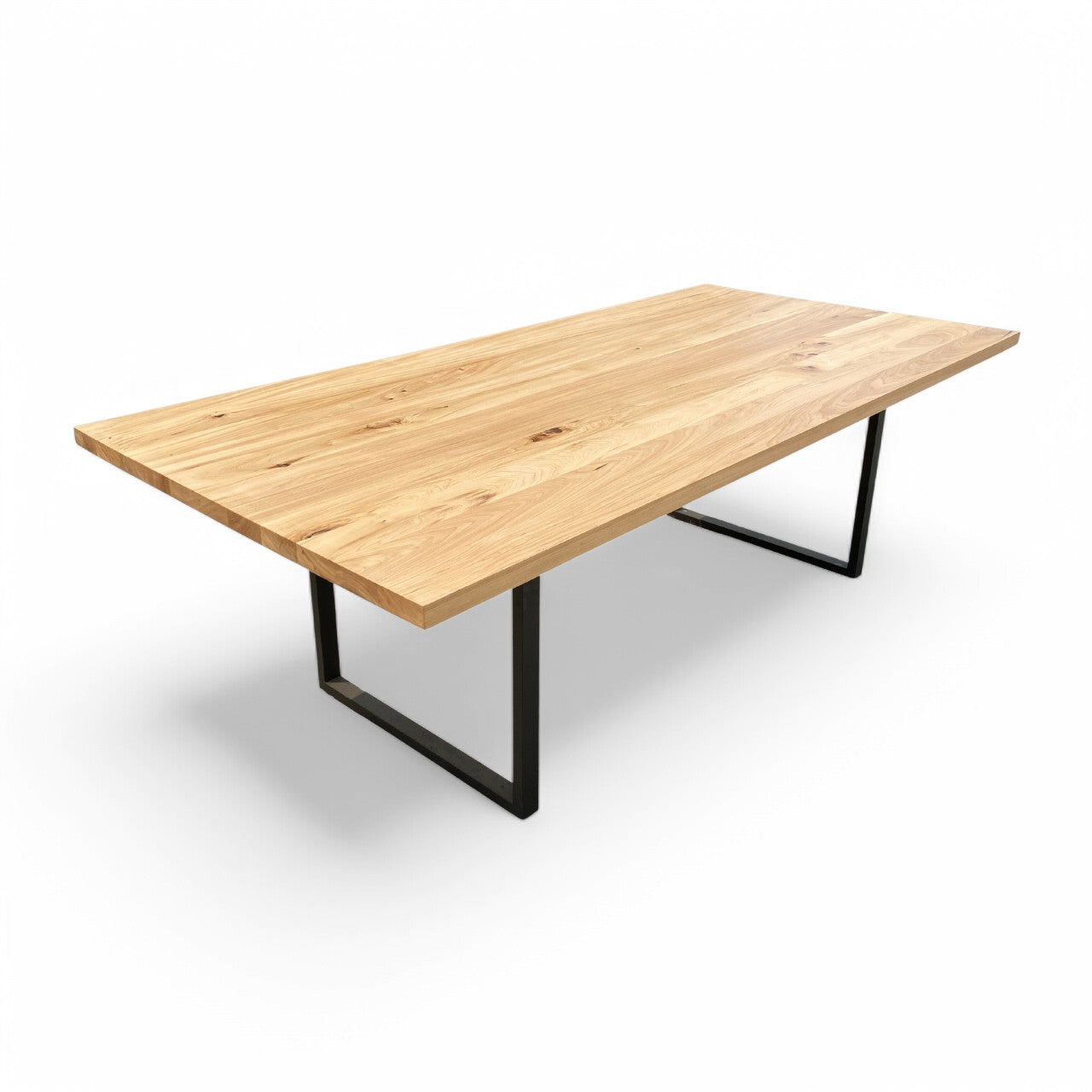 A rectangular dining table with a wood top and black metal legs.