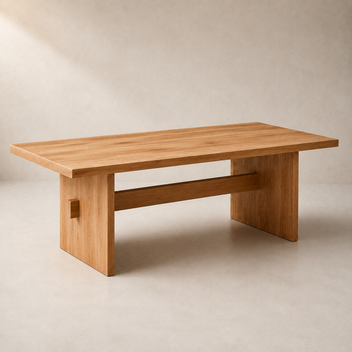 A minimalist wooden coffee table with a natural elm finish, featuring a thick rectangular tabletop, a central support beam, and a small square cutout detail on the side leg, set against a warm beige textured background.