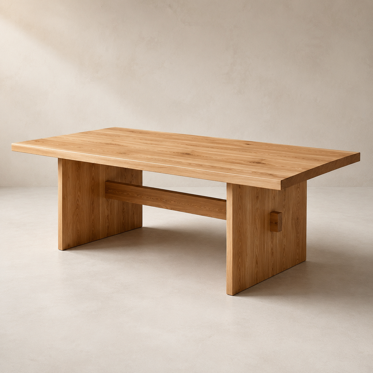 A minimalist wooden dining table with a natural elm top and blocky, geometric legs, shown in a warm, neutral studio setting.