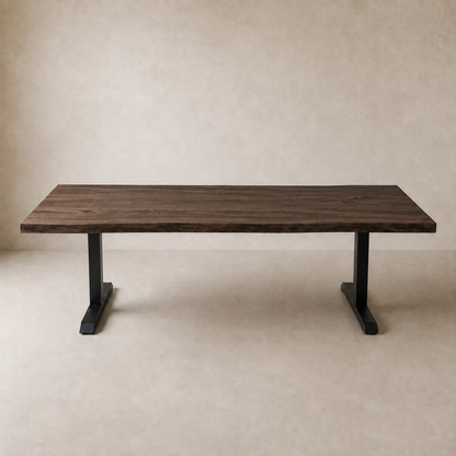 A rectangular wooden table with a dark brown live-edge top and black metal pedestal legs, set against a neutral beige textured background.