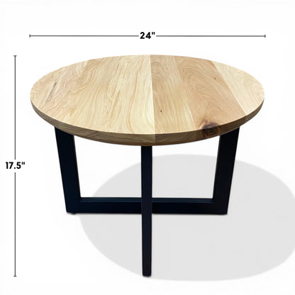 Urban Lumber round coffee table made from salvaged elm wood with natural grain and black metal legs. 24" diameter, 17.5" height.