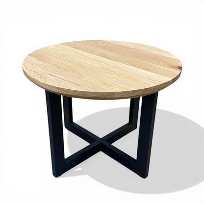 Urban Lumber classic round coffee table made from salvaged elm wood with a black metal base.