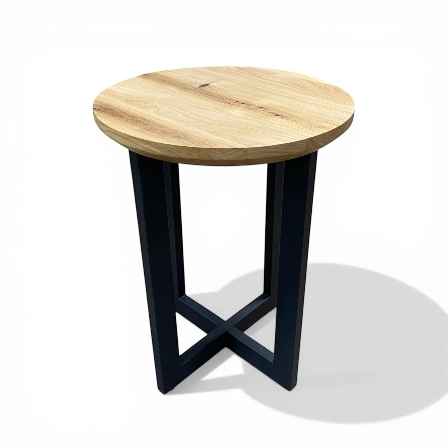 Urban Lumber classic round side table with natural elm wood top and black steel base with cross detail.