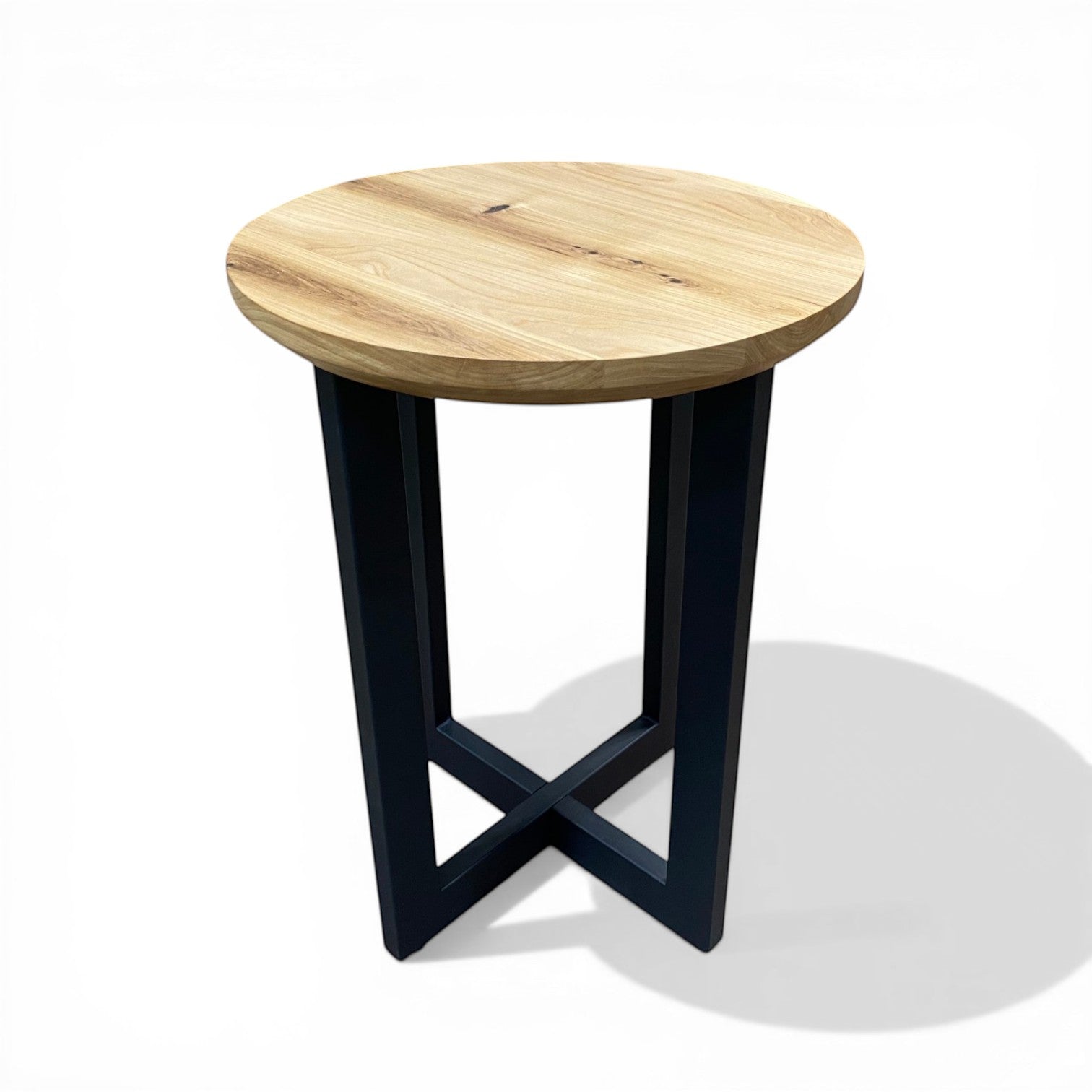 Urban Lumber classic round side table with natural elm wood top and black steel base with cross detail.